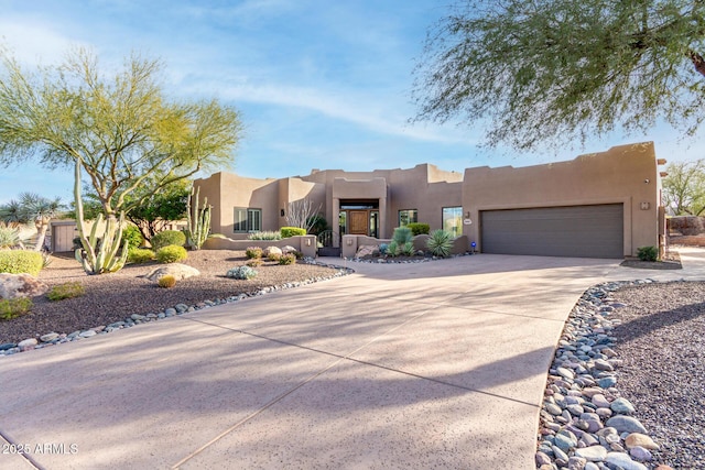 pueblo-style home featuring a garage