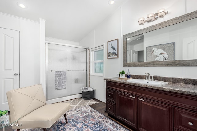 full bath featuring a shower stall, wood finished floors, and vanity