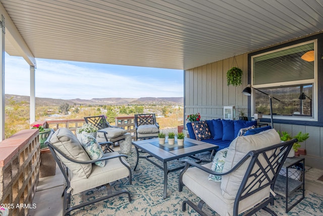 view of patio with a mountain view and an outdoor living space