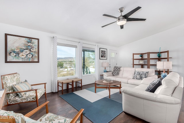 living room featuring ceiling fan, vaulted ceiling, and dark wood finished floors