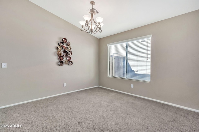 unfurnished room with carpet flooring, an inviting chandelier, and lofted ceiling