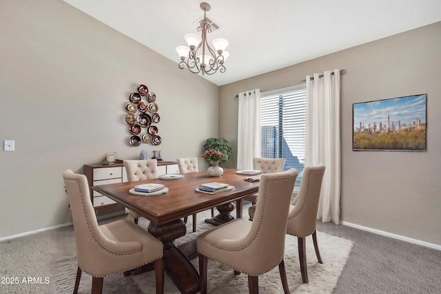 carpeted dining space featuring lofted ceiling and an inviting chandelier