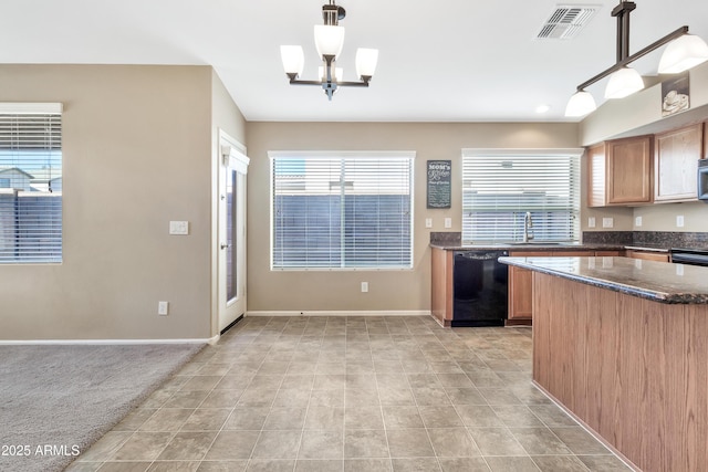 kitchen featuring sink, hanging light fixtures, an inviting chandelier, black dishwasher, and plenty of natural light