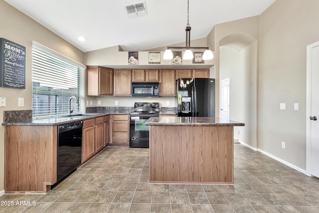 kitchen featuring pendant lighting, a center island, dark stone counters, black appliances, and sink