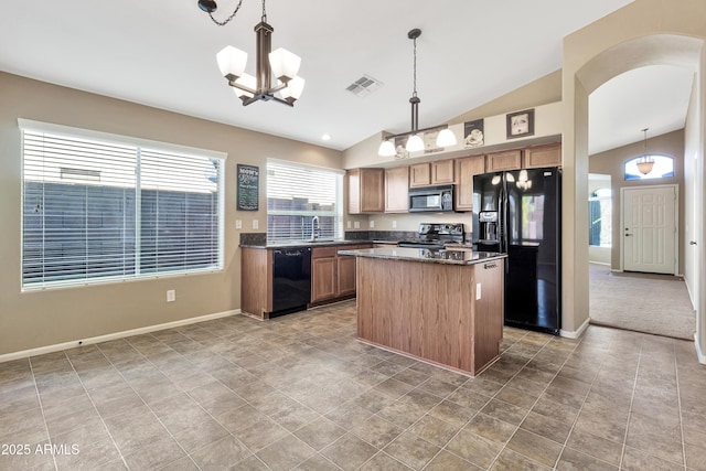 kitchen featuring pendant lighting, a center island, vaulted ceiling, and black appliances