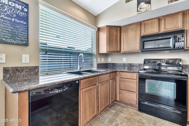 kitchen featuring sink, vaulted ceiling, dark stone counters, and black appliances