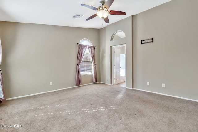 empty room featuring ceiling fan and light colored carpet