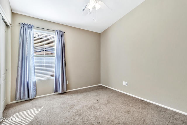 carpeted empty room featuring ceiling fan