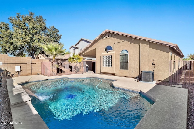 view of pool with central AC, a patio, and pool water feature