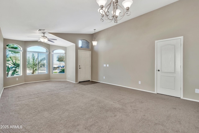 spare room featuring carpet, ceiling fan with notable chandelier, and lofted ceiling