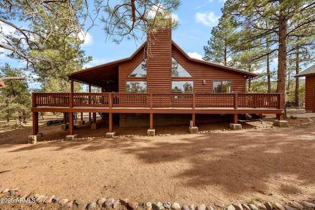 2761 Jaguar Cir, Overgaard, AZ 85933 - rear view of property with a deck, log veneer siding, and a chimney