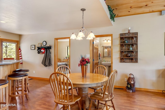 2761 Jaguar Cir, Overgaard, AZ 85933 - dining space featuring light wood-type flooring, baseboards, and a chandelier