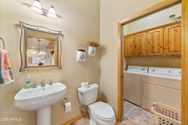 2761 Jaguar Cir, Overgaard, AZ 85933 - bathroom with independent washer and dryer, toilet, a chandelier, and baseboards