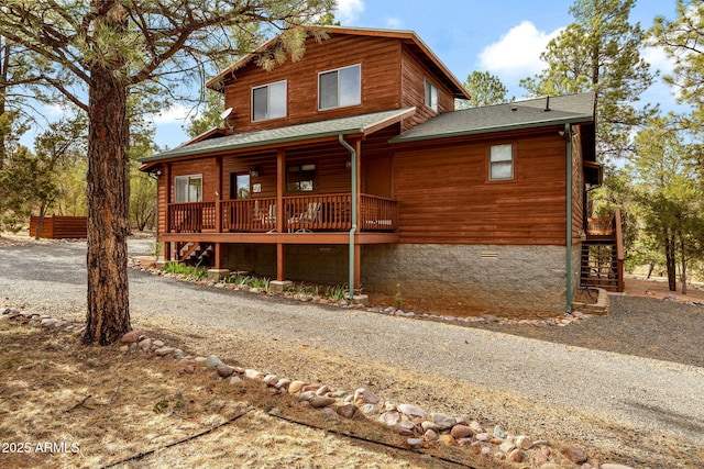2761 Jaguar Cir, Overgaard, AZ 85933 - view of front of property featuring stairway, a shingled roof, and covered porch