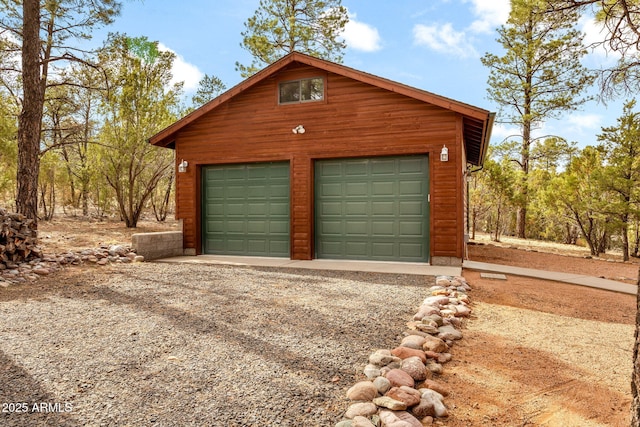2761 Jaguar Cir, Overgaard, AZ 85933 - detached garage featuring gravel driveway