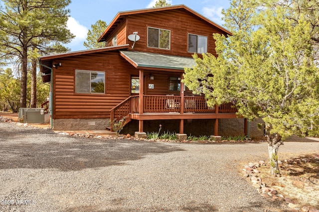 2761 Jaguar Cir, Overgaard, AZ 85933 - view of front of home featuring a porch, gravel driveway, crawl space, and roof with shingles