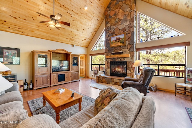 2761 Jaguar Cir, Overgaard, AZ 85933 - living area with wooden ceiling, a stone fireplace, high vaulted ceiling, a ceiling fan, and wood finished floors