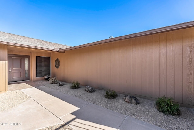 entrance to property featuring a patio