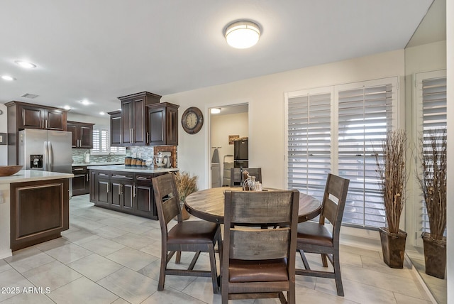 dining space with light tile patterned floors and sink