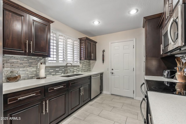 kitchen featuring tasteful backsplash, dark brown cabinetry, stainless steel appliances, sink, and light tile patterned floors