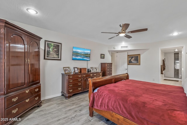 bedroom featuring ceiling fan, connected bathroom, and light hardwood / wood-style flooring