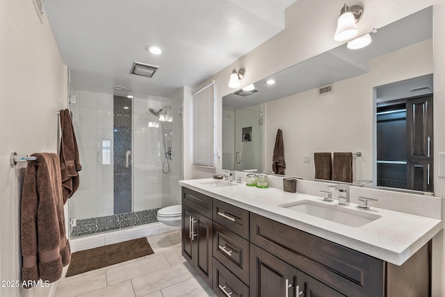 bathroom featuring tile patterned flooring, vanity, toilet, and an enclosed shower