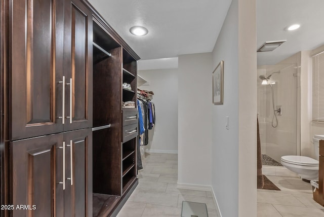 spacious closet with light tile patterned flooring