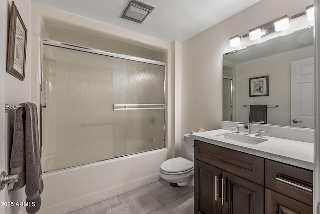 full bathroom with shower / bath combination with glass door, vanity, toilet, and tile patterned flooring