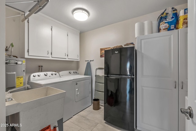 washroom with sink, cabinets, washing machine and dryer, electric water heater, and light tile patterned floors