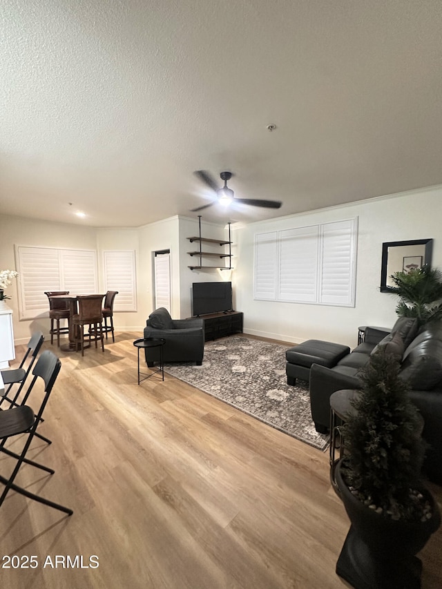 5345 E Van Buren St Unit 216, Phoenix, AZ 85008 - living room featuring light wood-style floors, a ceiling fan, and a textured ceiling