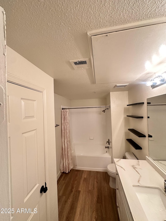 5345 E Van Buren St Unit 216, Phoenix, AZ 85008 - full bath with wood finished floors, a textured ceiling, vanity, and shower / tub combo with curtain