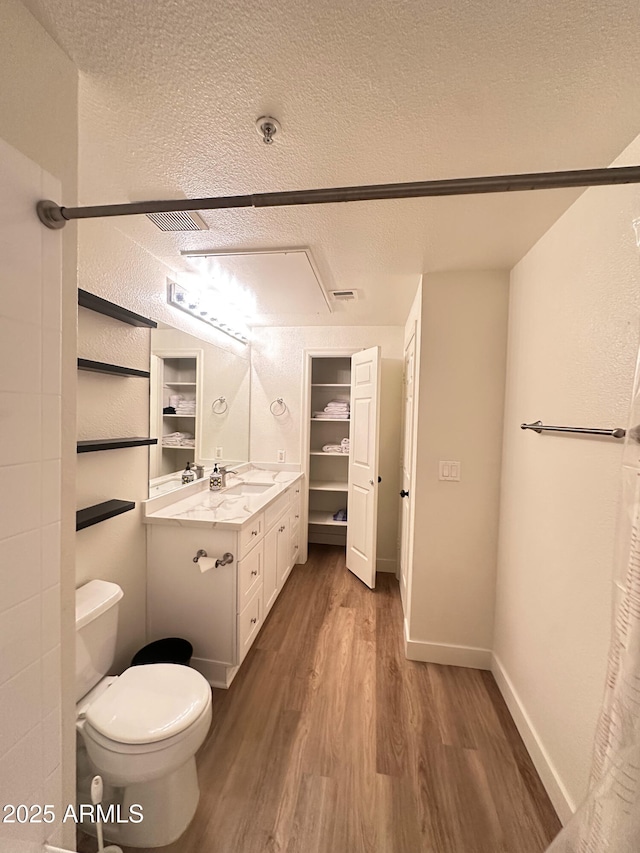5345 E Van Buren St Unit 216, Phoenix, AZ 85008 - bathroom featuring wood finished floors, a textured ceiling, and vanity
