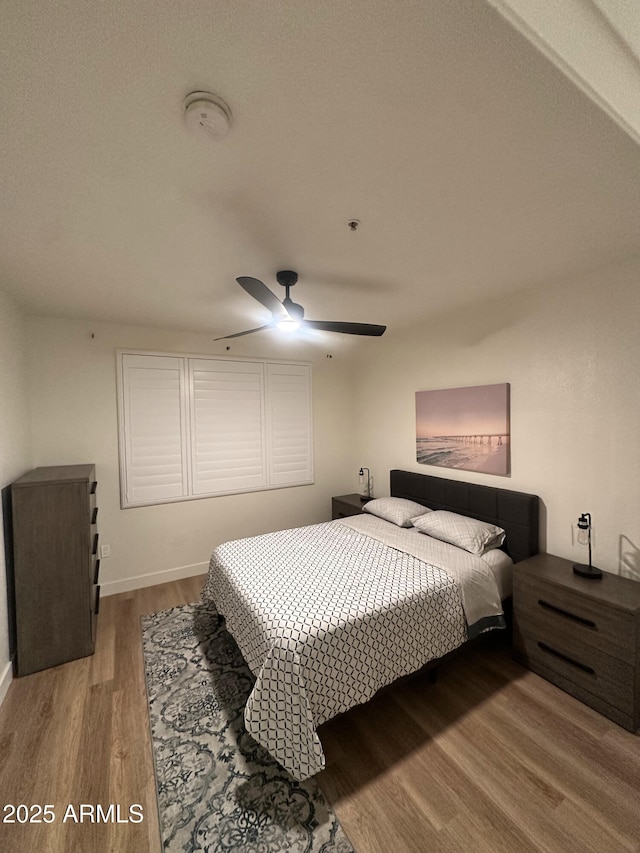 5345 E Van Buren St Unit 216, Phoenix, AZ 85008 - bedroom with wood finished floors and a ceiling fan