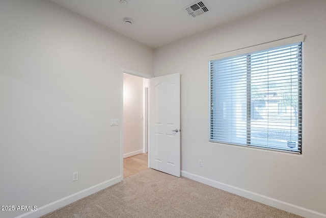 15853 N 74th Ave, Peoria, AZ 85382 - spare room featuring plenty of natural light, baseboards, visible vents, and light carpet