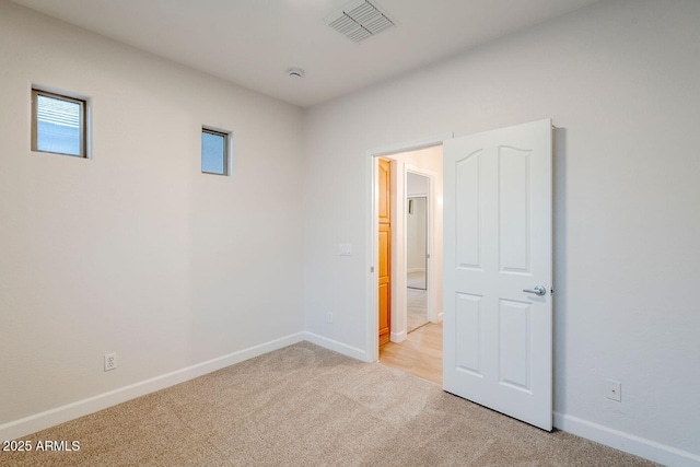 15853 N 74th Ave, Peoria, AZ 85382 - unfurnished room with visible vents, baseboards, and light colored carpet