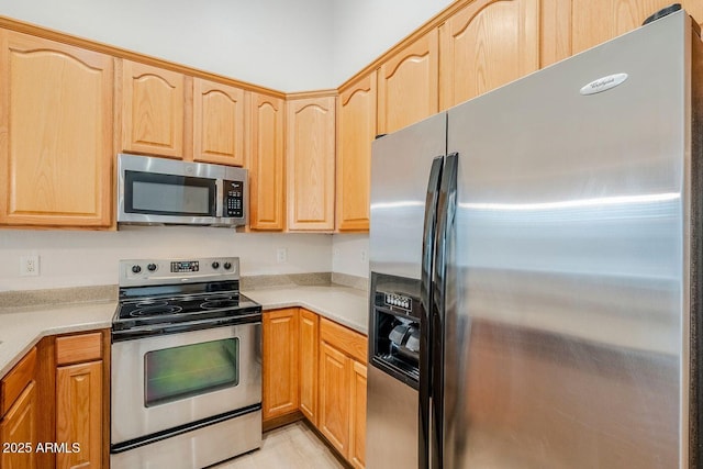 15853 N 74th Ave, Peoria, AZ 85382 - kitchen with light countertops, light brown cabinetry, and stainless steel appliances