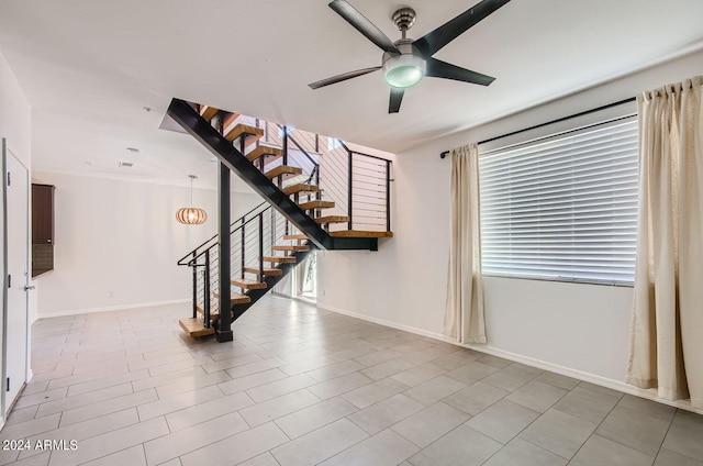 interior space featuring ceiling fan, plenty of natural light, and light tile patterned floors