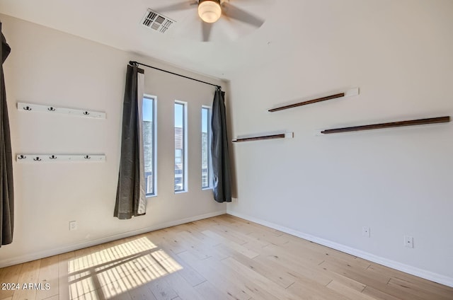 spare room with ceiling fan and light hardwood / wood-style flooring