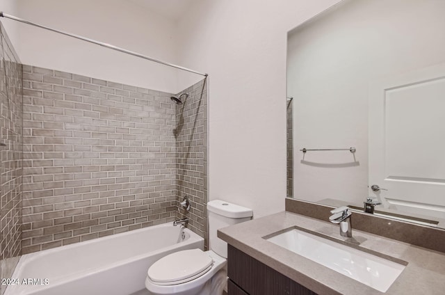 full bathroom with vanity, tiled shower / bath combo, and toilet