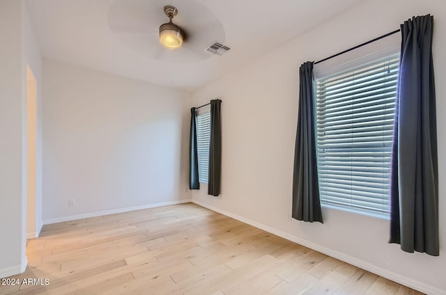 spare room with light hardwood / wood-style flooring and ceiling fan