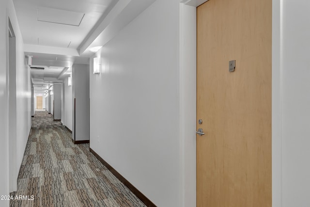 hall featuring carpet flooring