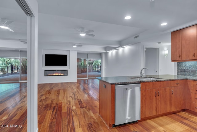 kitchen featuring sink, hardwood / wood-style flooring, decorative backsplash, and dishwasher