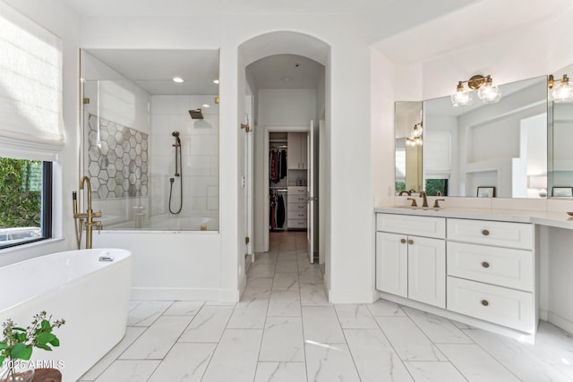 bathroom featuring independent shower and bath and vanity