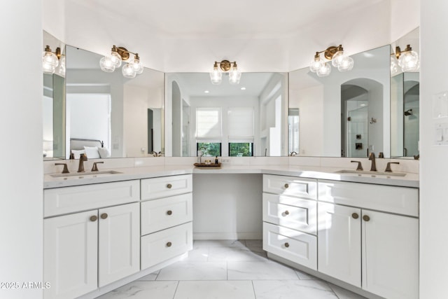 bathroom featuring vanity and a shower with door