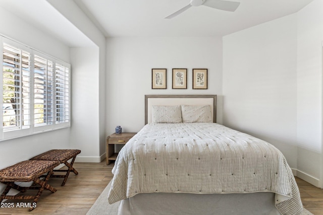 bedroom with ceiling fan and light hardwood / wood-style flooring