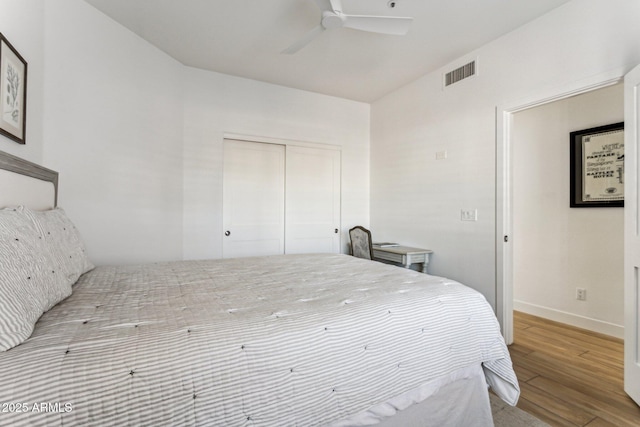 bedroom featuring light hardwood / wood-style flooring, a closet, and ceiling fan