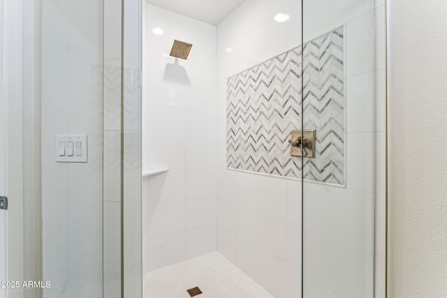 bathroom with a tile shower