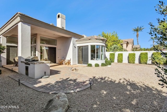 back of property featuring area for grilling and a patio area