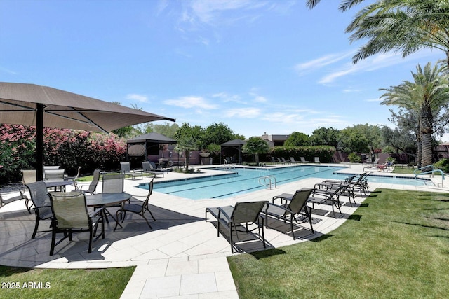 view of pool featuring a yard and a patio area