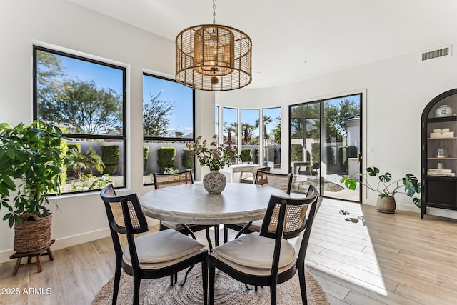 dining area featuring a chandelier and light hardwood / wood-style flooring